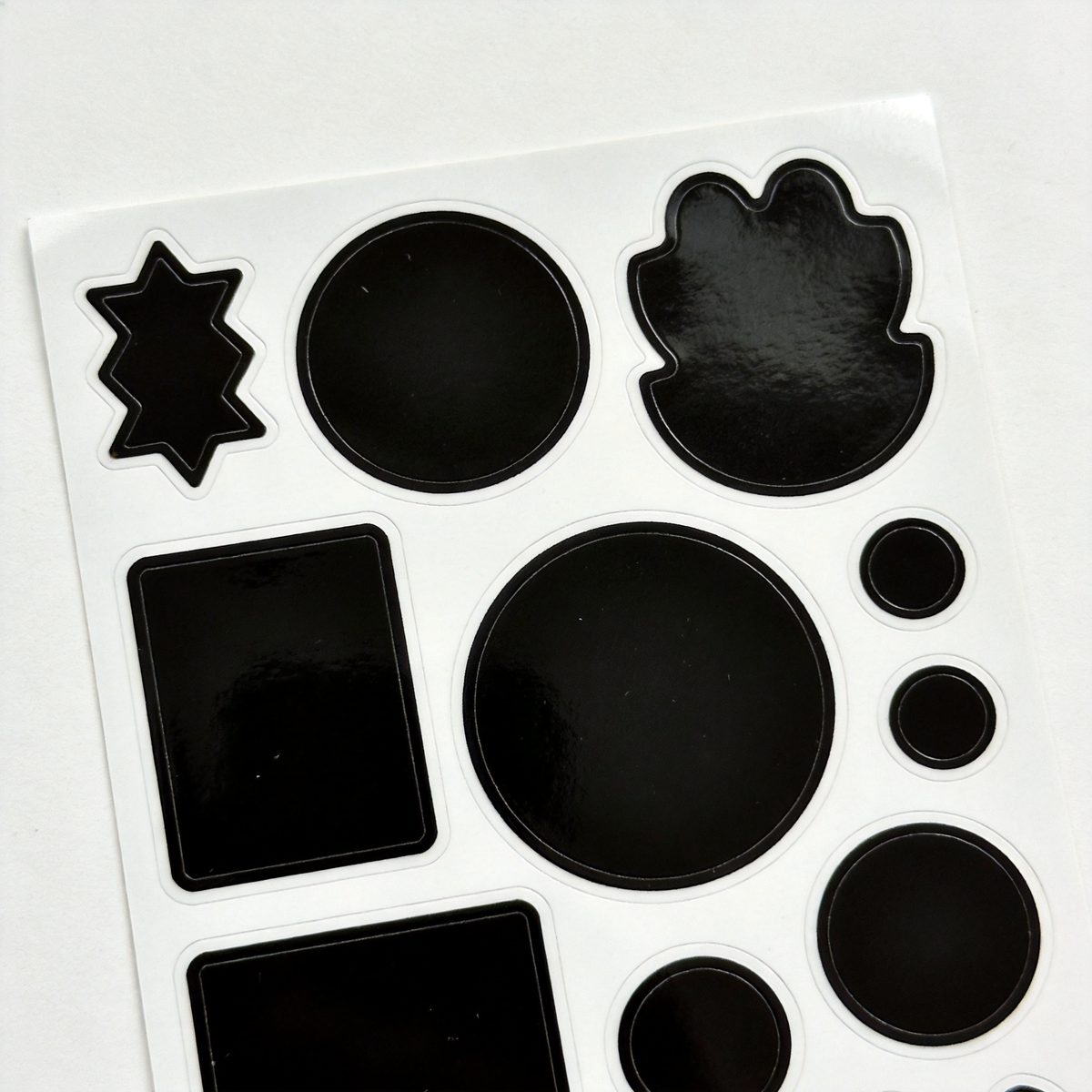 Die-cut sticker sheets with various shapes and finishes