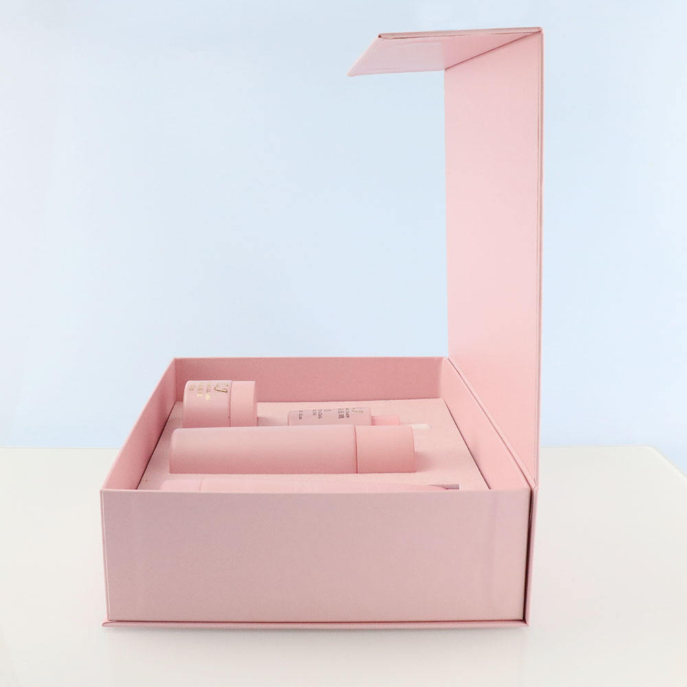 Open pink gift box with skincare product containers